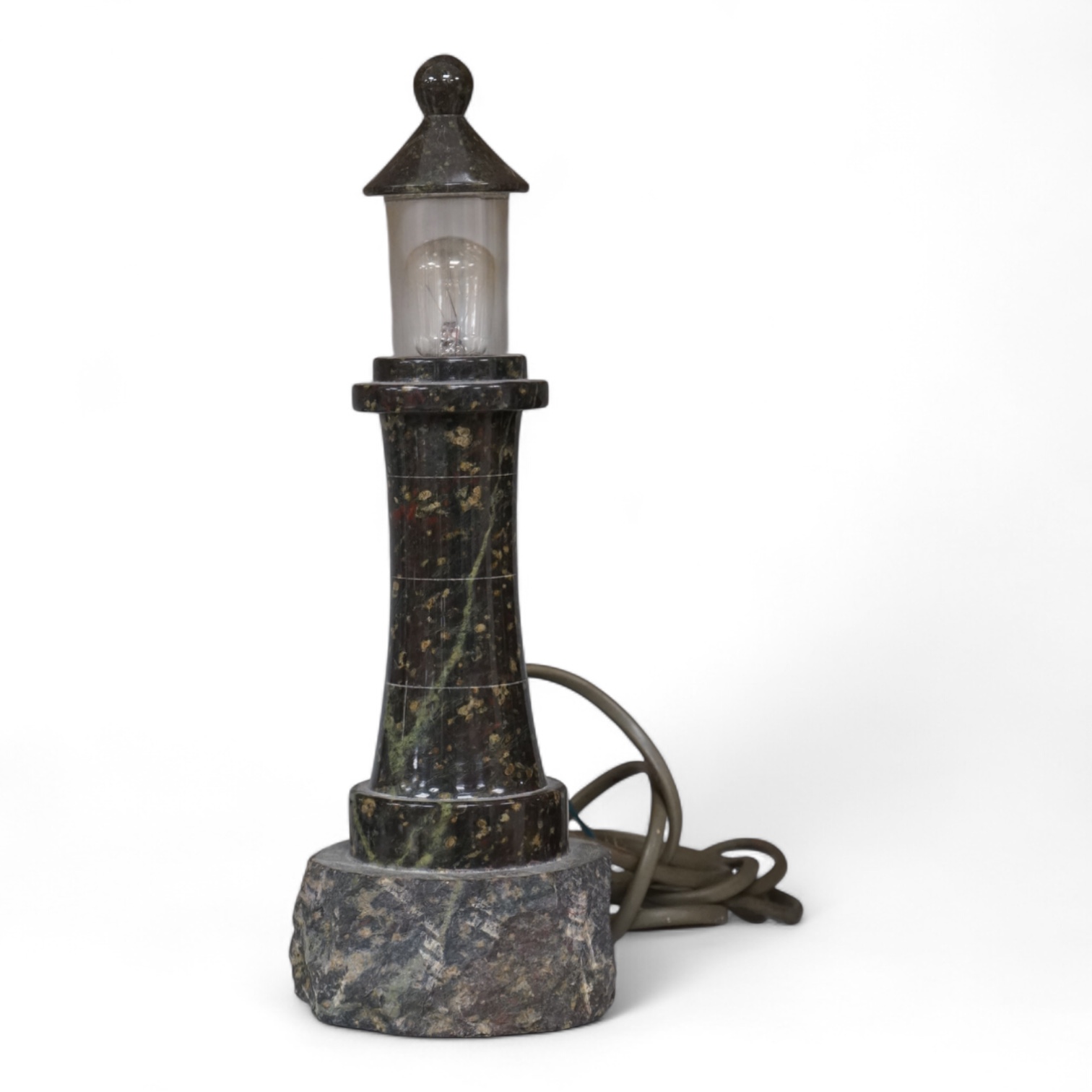 A Cornish serpentine lamp in the form of a lighthouse, 29cm high